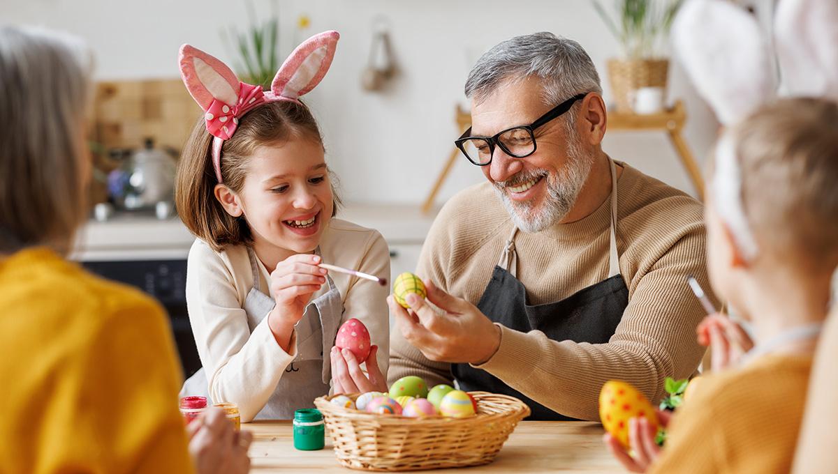 Article Cards Featured Image Happy family grandfather and little granddaughter holding wicker basket full of painted boiled eggs